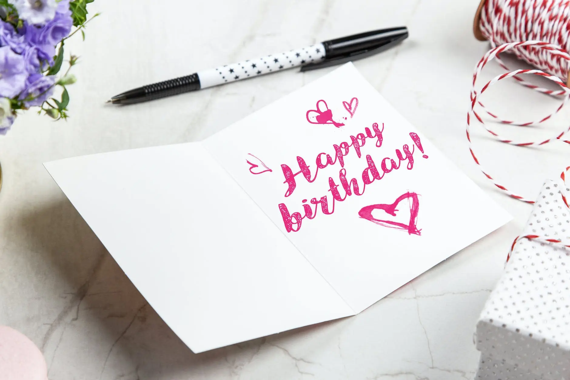 open birthday greeting card near pen