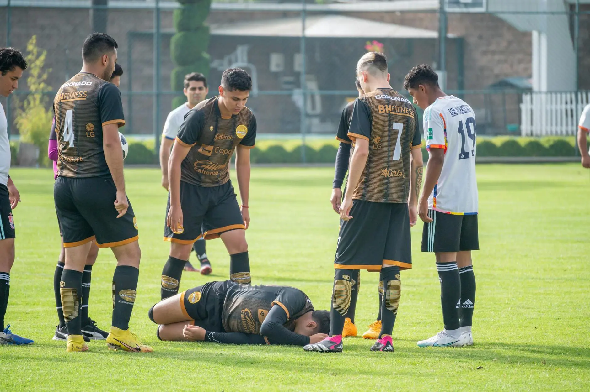 player lies with pain on football pitch