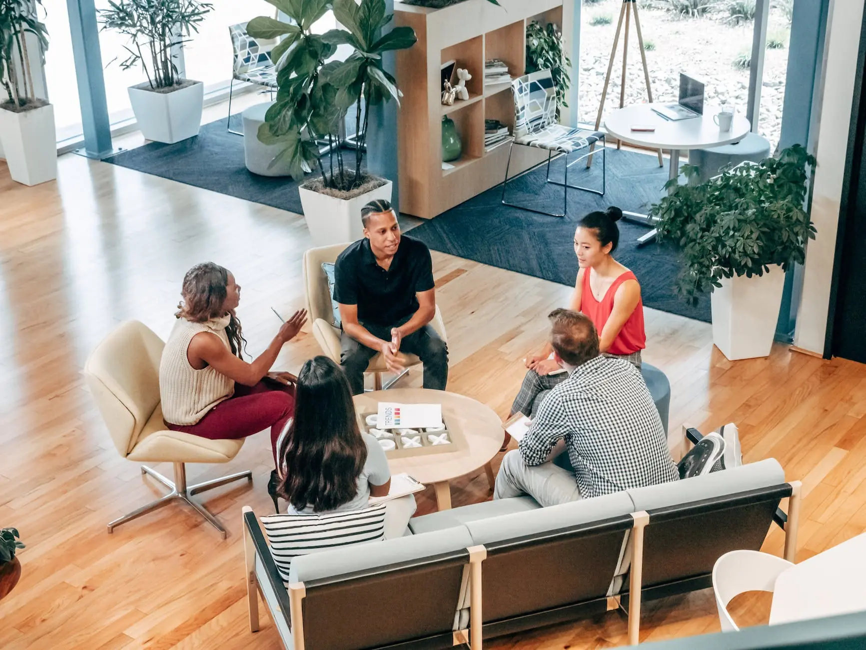 people sitting on chair in front of a table thinking of the top Marketing ideas for small business