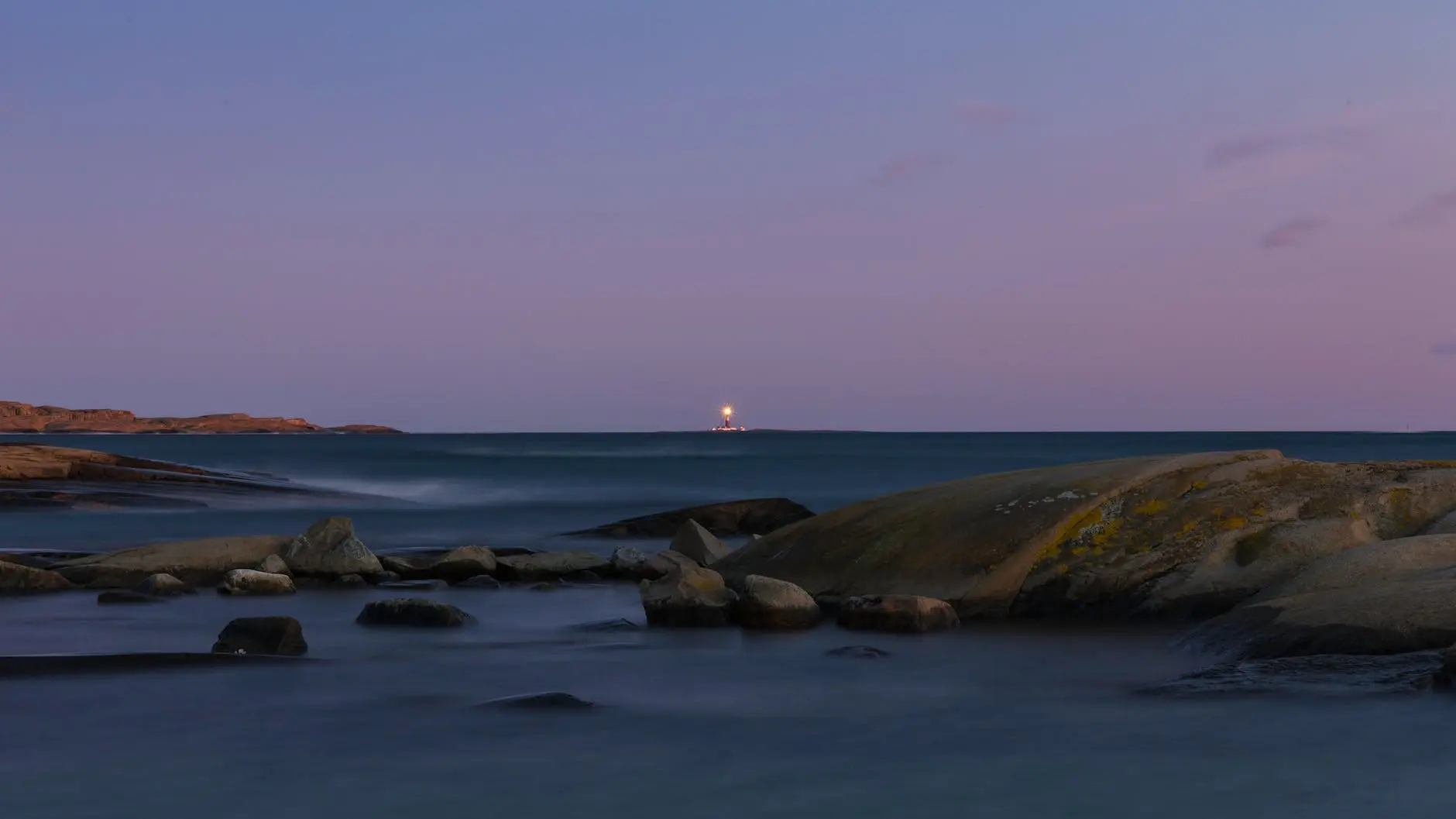 photo of body of water with boulders