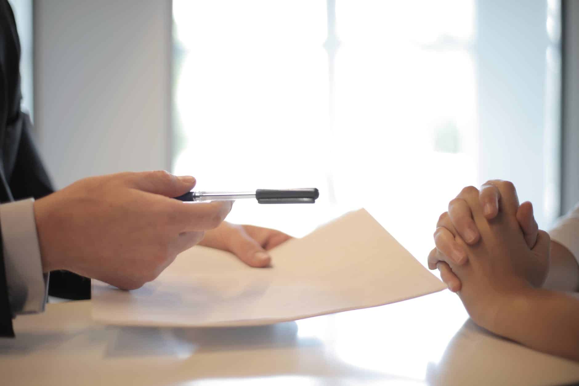 What is a rental property business plan?crop businessman giving contract to woman to sign
