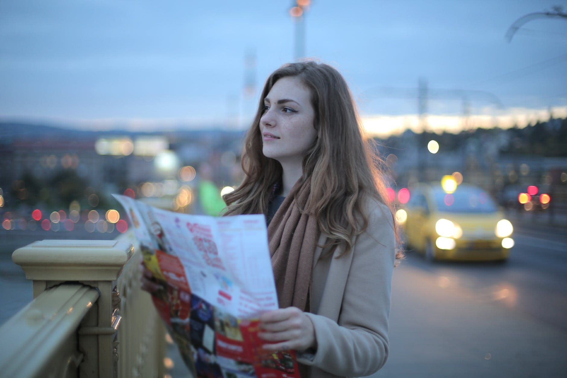 young woman with map looking away on Oslo Norway Rental Car Guide